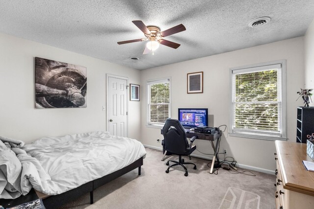 1830 Bradbury Rd, Adams, TN 37010 - bedroom featuring multiple windows, light colored carpet, a desk, a textured ceiling, and a ceiling fan