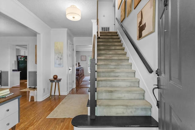 1830 Bradbury Rd, Adams, TN 37010 - foyer entrance with wood finished floors, stairs, ornamental molding, and a textured ceiling