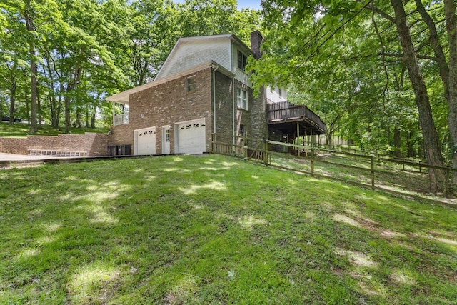 1830 Bradbury Rd, Adams, TN 37010 - view of side of property with a garage, brick siding, a chimney, and a deck