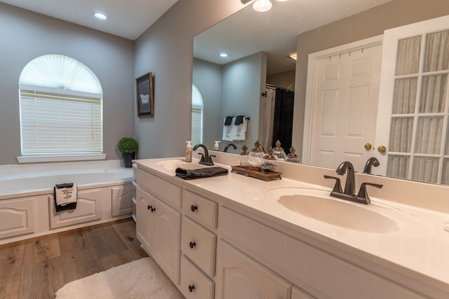 1699 Burnt Oak Dr Unit 195, Dalton, GA 30721 - bathroom with wood finished floors, double vanity, a garden tub, recessed lighting, and a shower with curtain