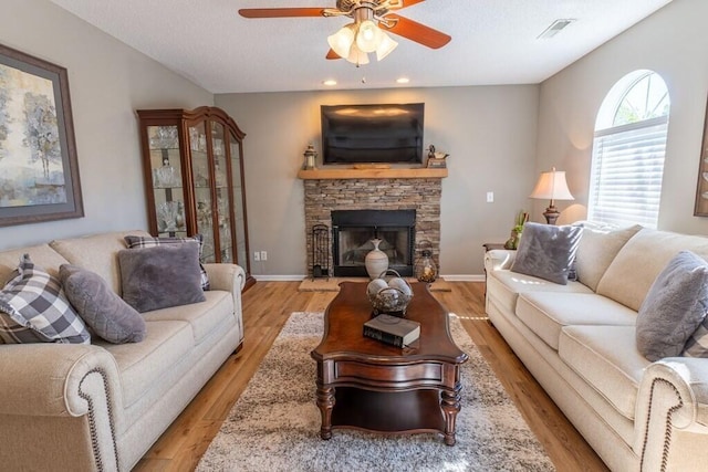 1699 Burnt Oak Dr Unit 195, Dalton, GA 30721 - living room with a ceiling fan, a stone fireplace, light wood-style flooring, recessed lighting, and a textured ceiling