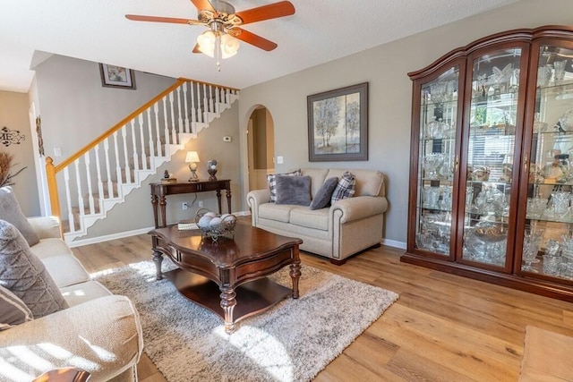 1699 Burnt Oak Dr Unit 195, Dalton, GA 30721 - living area featuring arched walkways, wood finished floors, stairway, and a ceiling fan