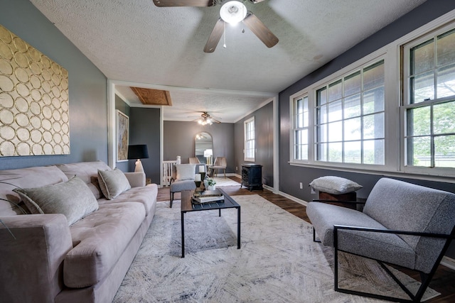 1529 W Grab Creek Rd, Dickson, TN 37055 - living room with a ceiling fan, a textured ceiling, plenty of natural light, wood finished floors, and a wood stove