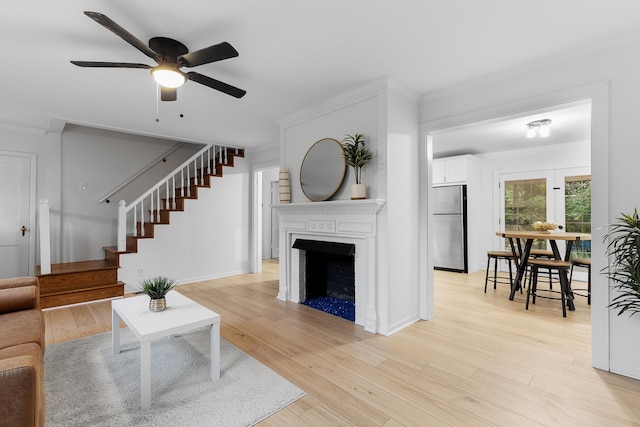 109 Anderson Dr, Chattanooga, TN 37421 - living area with a ceiling fan, a fireplace, stairs, light wood-style floors, and ornamental molding