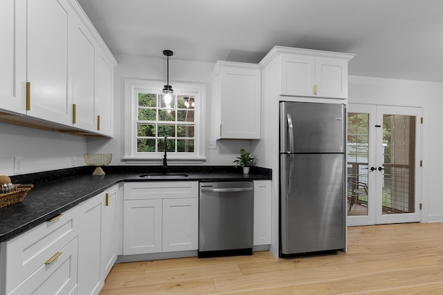 109 Anderson Dr, Chattanooga, TN 37421 - kitchen with appliances with stainless steel finishes, white cabinets, light wood finished floors, and french doors