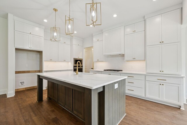 508 Matthew Miller Dr, Smyrna, TN 37167 - kitchen with decorative backsplash, white cabinets, a center island with sink, dark wood-style flooring, and recessed lighting