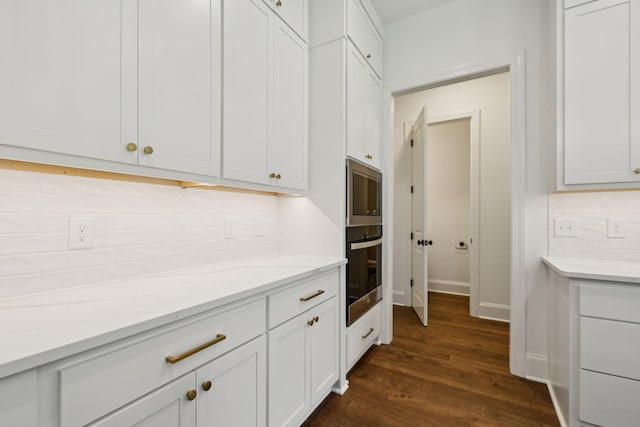 508 Matthew Miller Dr, Smyrna, TN 37167 - kitchen featuring decorative backsplash, stainless steel microwave, dark wood finished floors, light stone countertops, and white cabinets