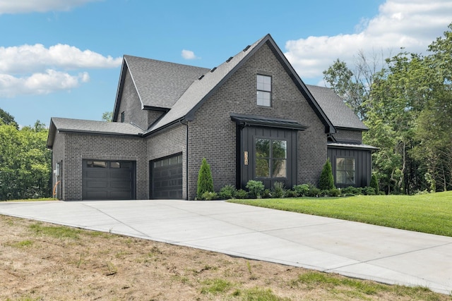 508 Matthew Miller Dr, Smyrna, TN 37167 - view of front facade featuring a garage, board and batten siding, a front yard, concrete driveway, and brick siding