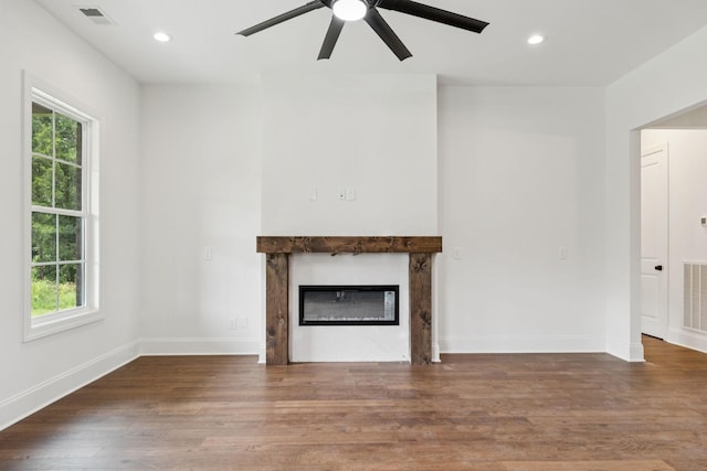 508 Matthew Miller Dr, Smyrna, TN 37167 - unfurnished living room with ceiling fan, healthy amount of natural light, a glass covered fireplace, wood finished floors, and recessed lighting