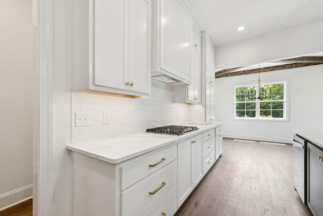 508 Matthew Miller Dr, Smyrna, TN 37167 - kitchen featuring appliances with stainless steel finishes, light stone countertops, tasteful backsplash, white cabinets, and recessed lighting