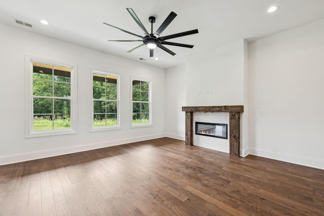 508 Matthew Miller Dr, Smyrna, TN 37167 - unfurnished living room featuring a glass covered fireplace, dark wood-style flooring, recessed lighting, and ceiling fan