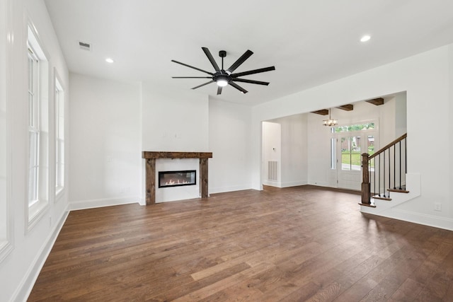 508 Matthew Miller Dr, Smyrna, TN 37167 - unfurnished living room with dark wood finished floors, a glass covered fireplace, a chandelier, a ceiling fan, and recessed lighting