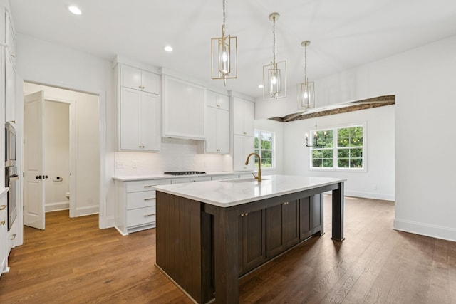 508 Matthew Miller Dr, Smyrna, TN 37167 - kitchen featuring cooktop, white cabinets, recessed lighting, dark wood-type flooring, and a kitchen island with sink