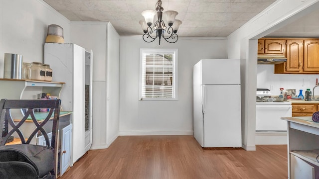 1676 Keeble St, Chattanooga, TN 37412 - kitchen featuring white appliances, under cabinet range hood, light wood-style floors, a chandelier, and light countertops