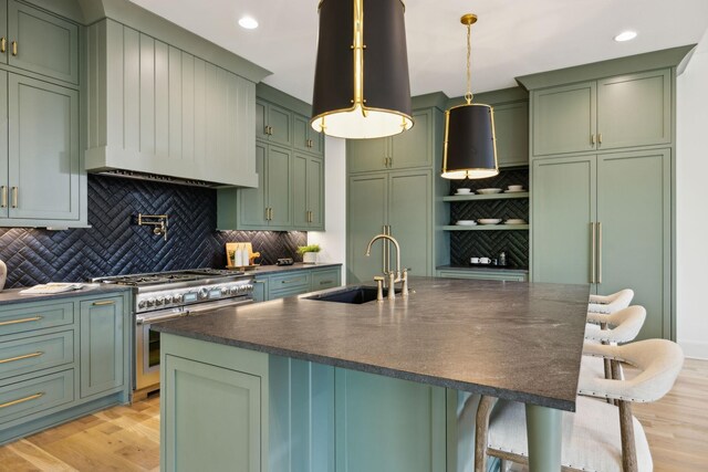8876 Edgecomb Dr, College Grove, TN 37046 - kitchen with green cabinetry, double oven range, tasteful backsplash, light wood-type flooring, and a kitchen bar