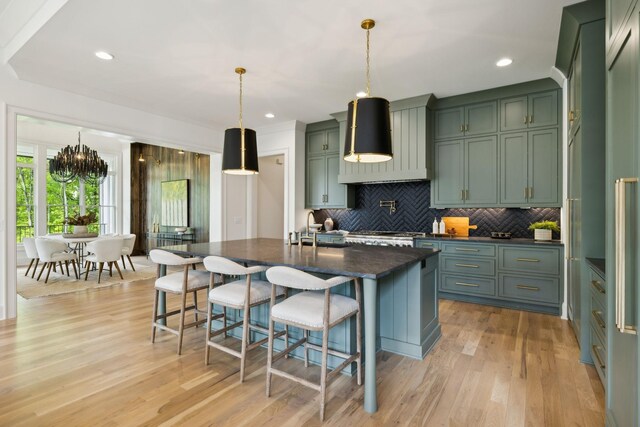 8876 Edgecomb Dr, College Grove, TN 37046 - kitchen with tasteful backsplash, premium range hood, a breakfast bar, light wood-style floors, and recessed lighting