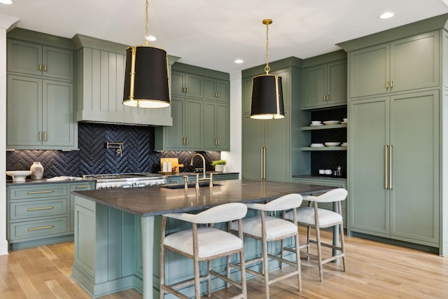 8876 Edgecomb Dr, College Grove, TN 37046 - kitchen featuring green cabinetry, backsplash, light wood-style flooring, recessed lighting, and a breakfast bar