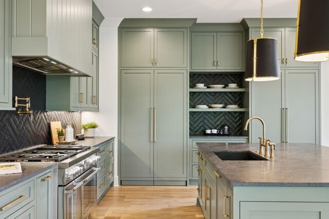 8876 Edgecomb Dr, College Grove, TN 37046 - kitchen with green cabinets, custom exhaust hood, high quality appliances, backsplash, and stone countertops