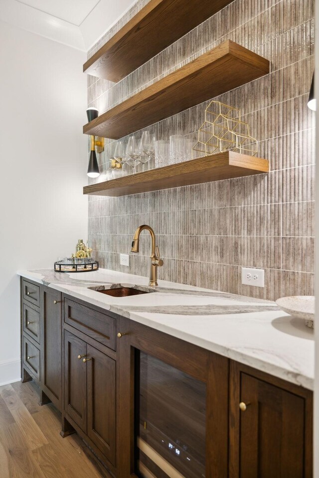 8876 Edgecomb Dr, College Grove, TN 37046 - indoor wet bar featuring decorative backsplash, wood finished floors, and beverage cooler