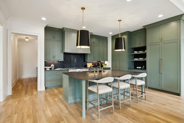 8876 Edgecomb Dr, College Grove, TN 37046 - kitchen featuring green cabinetry, dark countertops, light wood-style floors, custom exhaust hood, and recessed lighting
