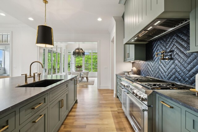8876 Edgecomb Dr, College Grove, TN 37046 - kitchen featuring double oven range, premium range hood, a chandelier, backsplash, and light wood-style floors