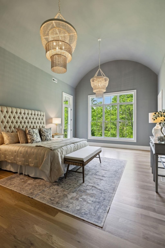 8876 Edgecomb Dr, College Grove, TN 37046 - bedroom featuring a chandelier, vaulted ceiling, and wood finished floors