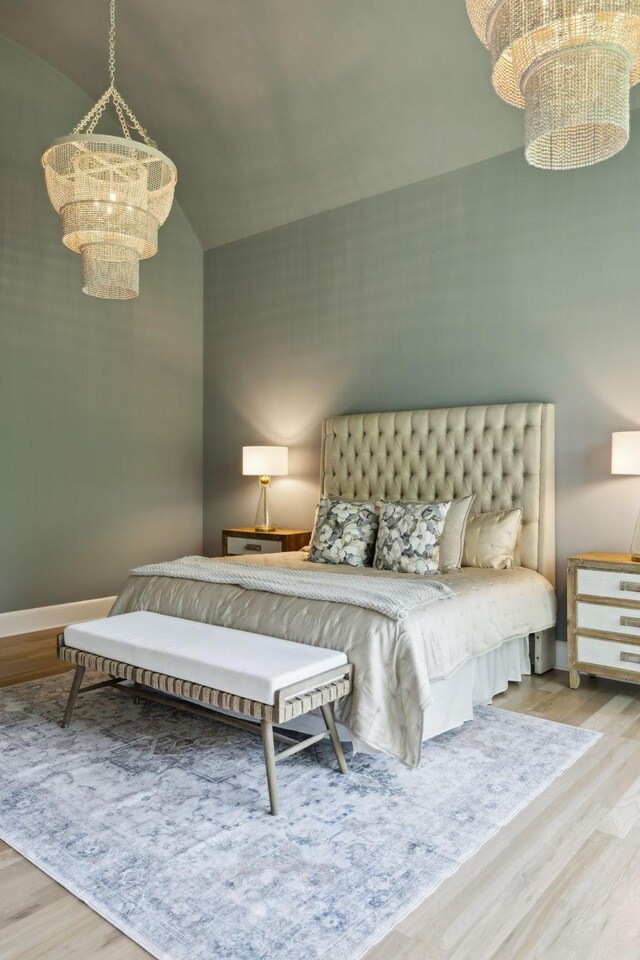 8876 Edgecomb Dr, College Grove, TN 37046 - bedroom featuring a chandelier, wood finished floors, and a towering ceiling
