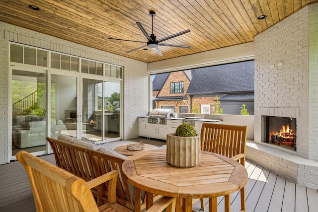 8876 Edgecomb Dr, College Grove, TN 37046 - deck featuring area for grilling, an outdoor brick fireplace, a ceiling fan, and outdoor dining area