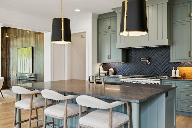 8876 Edgecomb Dr, College Grove, TN 37046 - kitchen with green cabinetry, light wood-style floors, tasteful backsplash, wall chimney exhaust hood, and recessed lighting
