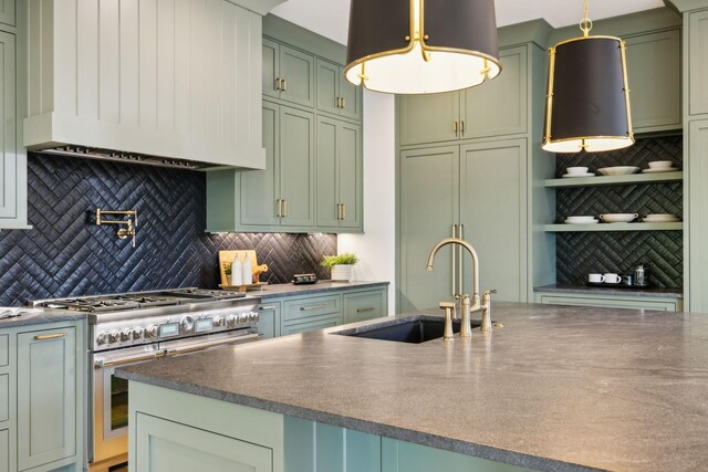 8876 Edgecomb Dr, College Grove, TN 37046 - kitchen with green cabinetry, custom exhaust hood, stainless steel stove, and decorative backsplash