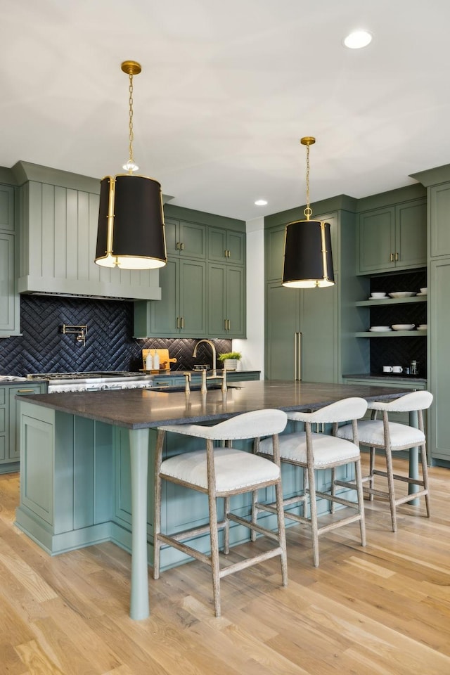8876 Edgecomb Dr, College Grove, TN 37046 - kitchen featuring green cabinets, backsplash, light wood-style flooring, decorative light fixtures, and recessed lighting
