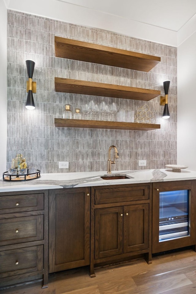 8876 Edgecomb Dr, College Grove, TN 37046 - indoor wet bar featuring wine cooler, light wood finished floors, and tasteful backsplash