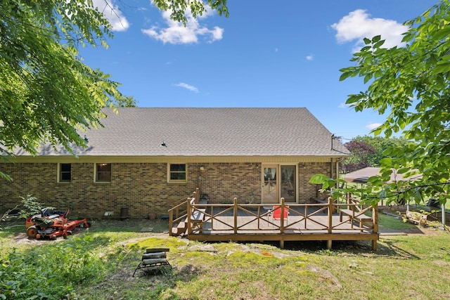 8663 Dog Branch Rd, Mount Pleasant, TN 38474 - back of house with brick siding, roof with shingles, a lawn, and a wooden deck