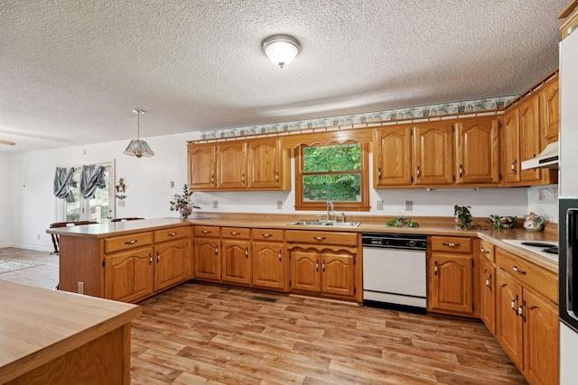 8663 Dog Branch Rd, Mount Pleasant, TN 38474 - kitchen with dishwasher, a peninsula, a textured ceiling, brown cabinets, and light wood finished floors