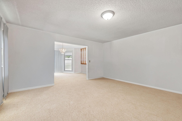 8663 Dog Branch Rd, Mount Pleasant, TN 38474 - spare room with a chandelier, a textured ceiling, and light carpet
