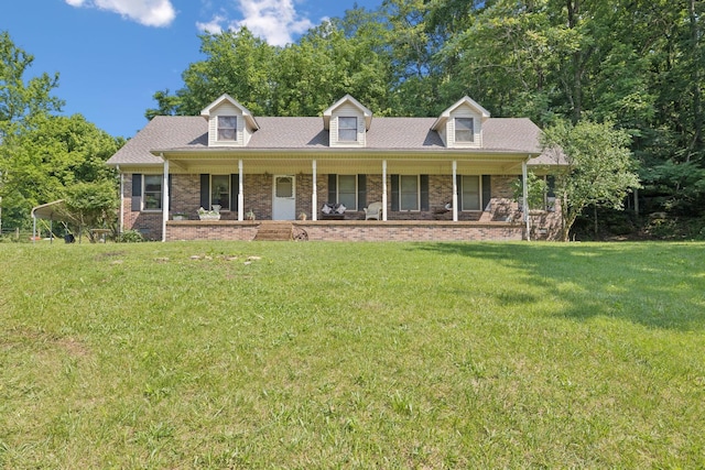 8663 Dog Branch Rd, Mount Pleasant, TN 38474 - cape cod house featuring covered porch, a front yard, and brick siding