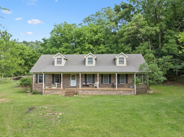 8663 Dog Branch Rd, Mount Pleasant, TN 38474 - cape cod house featuring covered porch, a front yard, brick siding, and a shingled roof