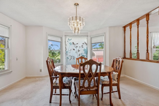 8663 Dog Branch Rd, Mount Pleasant, TN 38474 - dining room featuring plenty of natural light, a chandelier, light carpet, and a textured ceiling