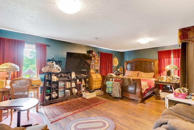 997 W 12th St, Chickamauga, GA 30707 - bedroom with a textured ceiling and wood finished floors