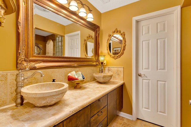 997 W 12th St, Chickamauga, GA 30707 - bathroom featuring double vanity and tasteful backsplash