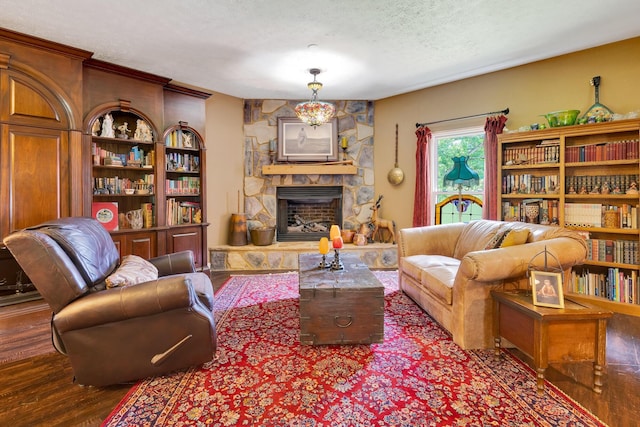 997 W 12th St, Chickamauga, GA 30707 - living area with a textured ceiling, a stone fireplace, and wood finished floors