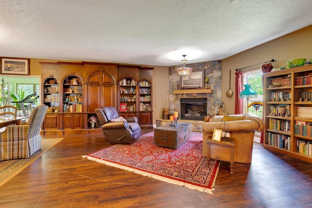 997 W 12th St, Chickamauga, GA 30707 - living area with a textured ceiling, a stone fireplace, and wood finished floors
