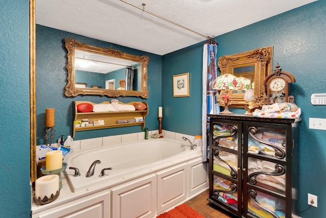 997 W 12th St, Chickamauga, GA 30707 - full bath with a garden tub, a textured wall, wood finished floors, and a textured ceiling