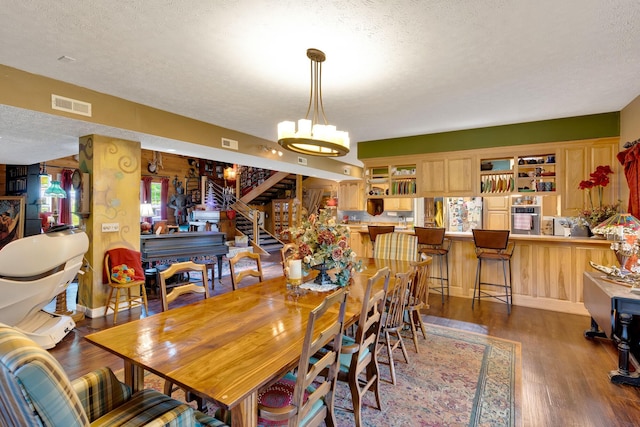 997 W 12th St, Chickamauga, GA 30707 - dining area with a textured ceiling, wood finished floors, a chandelier, and stairway
