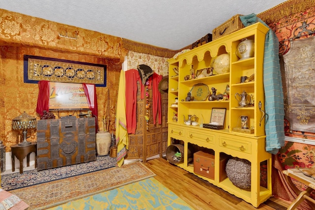 997 W 12th St, Chickamauga, GA 30707 - living area featuring wood finished floors, a textured ceiling, and wallpapered walls