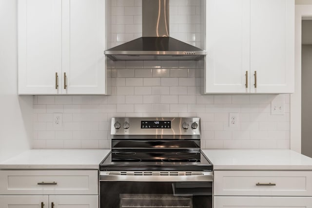 3046 Patton Branch Rd, Goodlettsville, TN 37072 - kitchen featuring stainless steel range with electric cooktop, wall chimney range hood, light countertops, and white cabinets