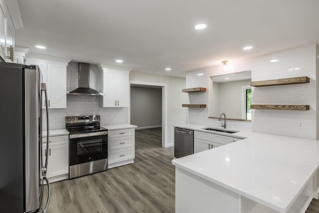 3046 Patton Branch Rd, Goodlettsville, TN 37072 - kitchen featuring appliances with stainless steel finishes, wall chimney range hood, open shelves, a peninsula, and tasteful backsplash