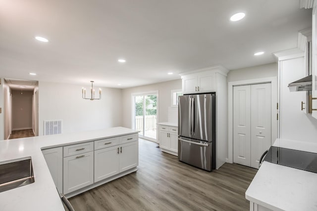 3046 Patton Branch Rd, Goodlettsville, TN 37072 - kitchen featuring freestanding refrigerator, wood finished floors, light countertops, white cabinets, and recessed lighting