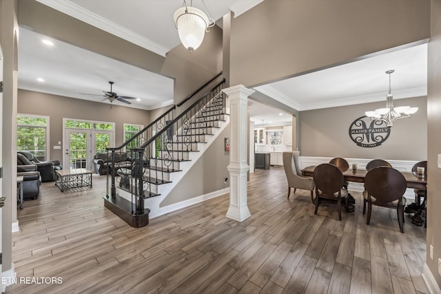 108 Center Park Ln, Oak Ridge, TN 37830 - staircase with a ceiling fan, wood finished floors, crown molding, decorative columns, and a chandelier