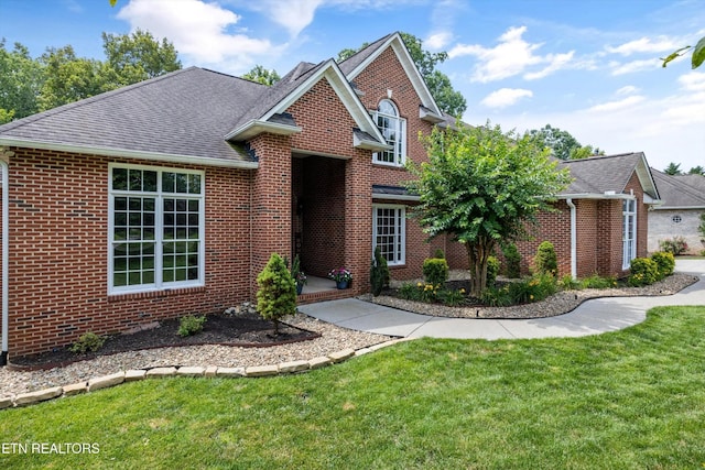 108 Center Park Ln, Oak Ridge, TN 37830 - traditional-style home featuring brick siding, roof with shingles, and a front yard